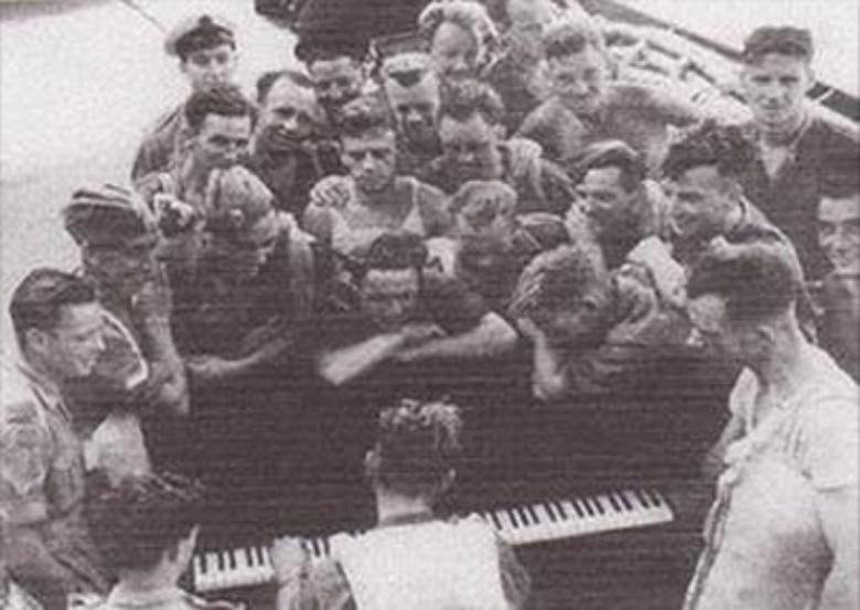 Men relaxing around Piano